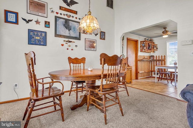 414 Riverview Rd, Forked River, NJ 08731 - dining room featuring ceiling fan, carpet flooring, arched walkways, and a chandelier