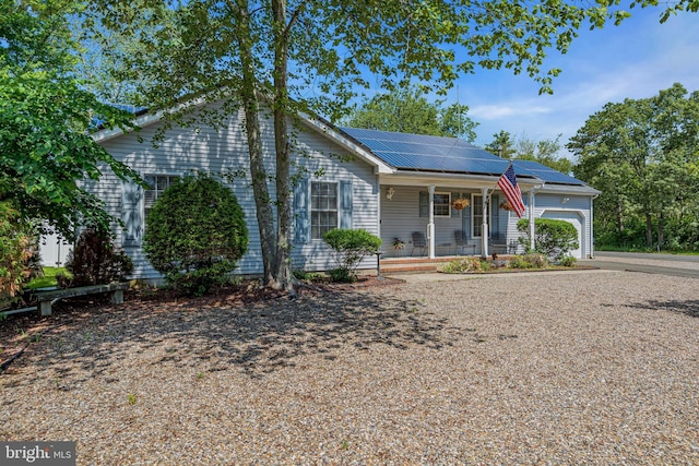 414 Riverview Rd, Forked River, NJ 08731 - ranch-style house featuring a porch, a garage, solar panels, driveway, and a metal roof