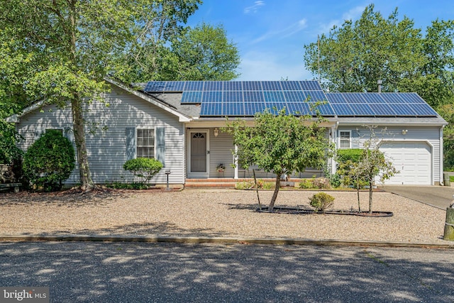 414 Riverview Rd, Forked River, NJ 08731 - view of front of house with a garage, solar panels, and concrete driveway