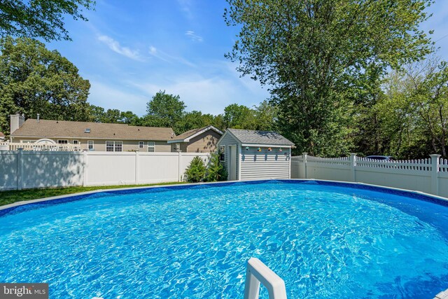 414 Riverview Rd, Forked River, NJ 08731 - view of pool with a fenced backyard and a storage unit