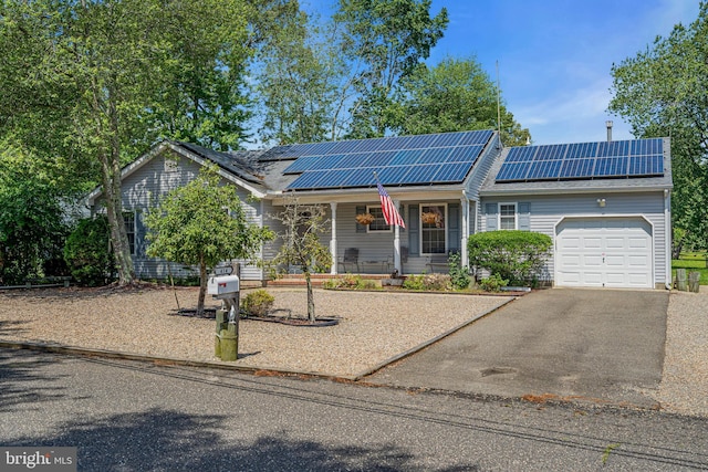 414 Riverview Rd, Forked River, NJ 08731 - ranch-style home with covered porch, a garage, asphalt driveway, and roof mounted solar panels