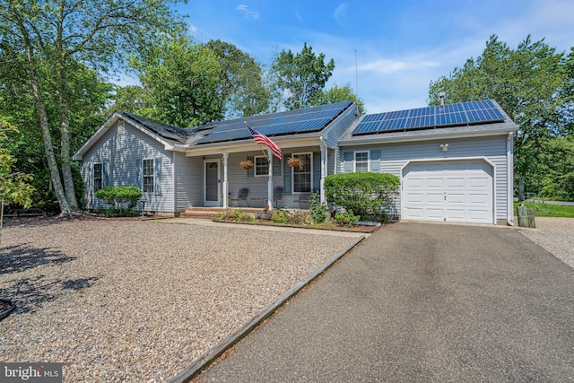 414 Riverview Rd, Forked River, NJ 08731 - single story home with covered porch, an attached garage, driveway, and roof mounted solar panels