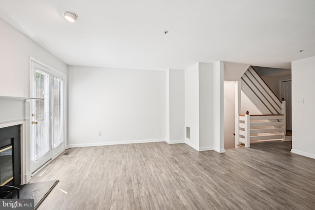 450 Hartford Sq Unit 7, West Chester, PA 19380 - unfurnished living room with a premium fireplace, wood finished floors, and stairway