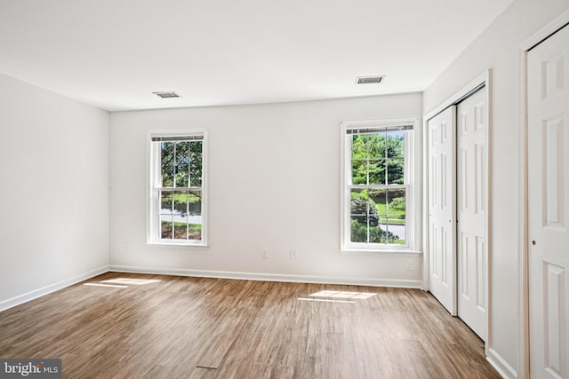 450 Hartford Sq Unit 7, West Chester, PA 19380 - unfurnished bedroom with wood finished floors and multiple windows