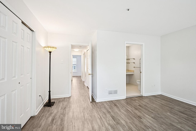 450 Hartford Sq Unit 7, West Chester, PA 19380 - unfurnished bedroom featuring wood finished floors, a closet, and connected bathroom
