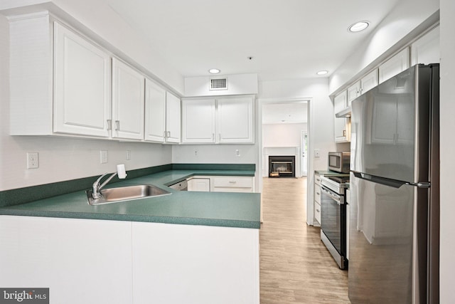 450 Hartford Sq Unit 7, West Chester, PA 19380 - kitchen with stainless steel appliances, light wood finished floors, white cabinetry, a peninsula, and recessed lighting