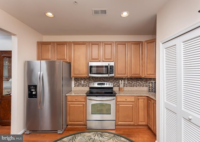 637 Wallingford Rd Unit 202, Bel Air, MD 21014 - kitchen with stainless steel appliances, light wood-style flooring, light stone countertops, tasteful backsplash, and recessed lighting