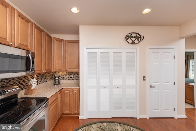 637 Wallingford Rd Unit 202, Bel Air, MD 21014 - kitchen with stainless steel appliances, light wood-type flooring, backsplash, recessed lighting, and light stone countertops