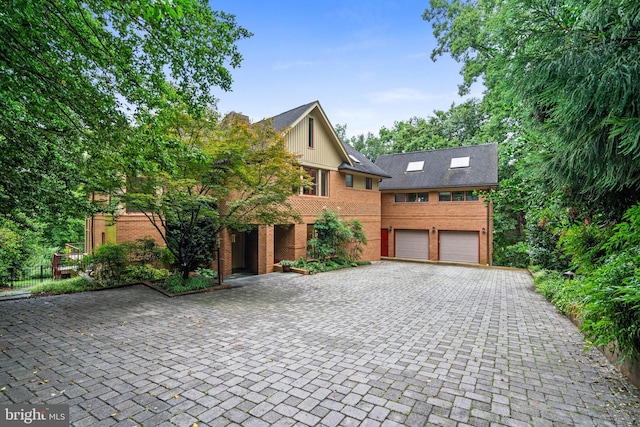 2714 Quebec St NW, Washington, DC 20008 - view of front facade featuring driveway, an attached garage, and brick siding