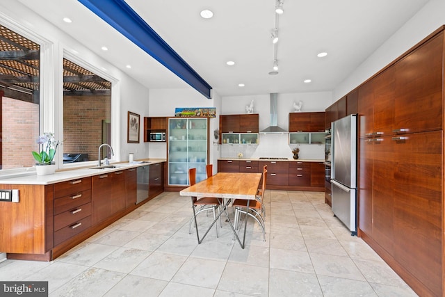 2714 Quebec St NW, Washington, DC 20008 - kitchen with wall chimney range hood, appliances with stainless steel finishes, light countertops, modern cabinets, and recessed lighting