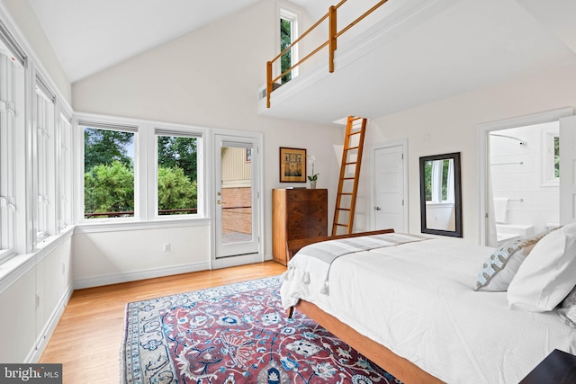 2714 Quebec St NW, Washington, DC 20008 - bedroom with access to exterior, light wood-style flooring, connected bathroom, and high vaulted ceiling