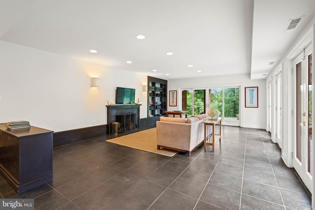 2714 Quebec St NW, Washington, DC 20008 - living area featuring a fireplace with flush hearth, recessed lighting, and dark tile patterned floors