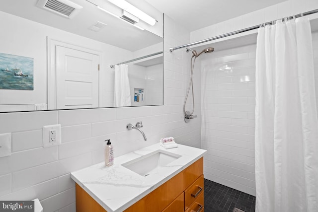 2714 Quebec St NW, Washington, DC 20008 - full bathroom with tile walls, vanity, a tile shower, and tile patterned flooring