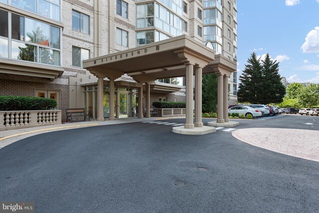 19385 Cypress Ridge Ter Unit 503, Leesburg, VA 20176 - view of apartment building / complex with uncovered parking