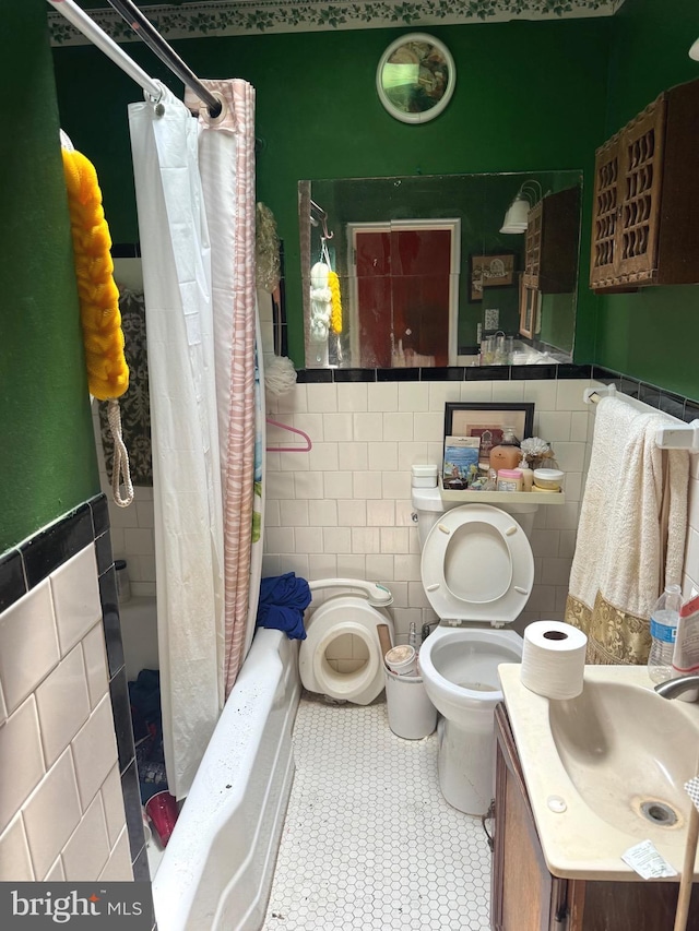 909 Bonaparte Ave, Baltimore, MD 21218 - bathroom with tile walls, vanity, wainscoting, and shower / bathtub combination with curtain