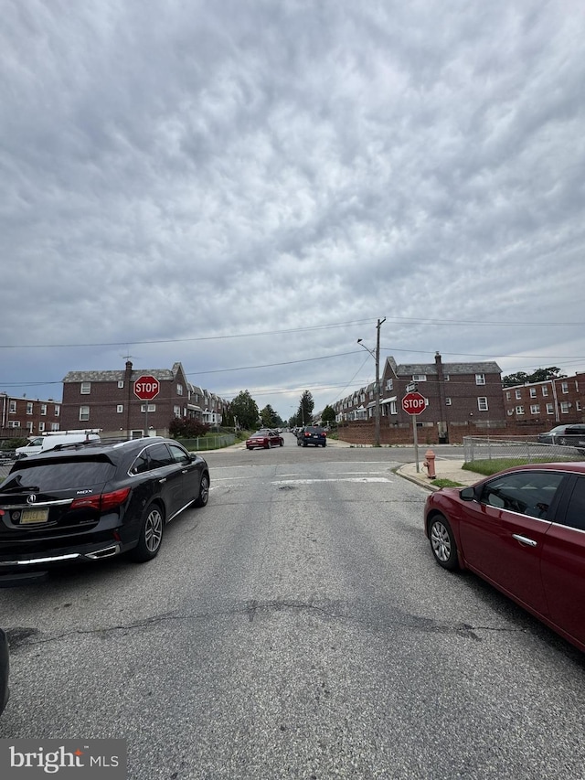 7553 Gilbert St, Philadelphia, PA 19150 - view of asphalt street with traffic signs, street lights, and curbs