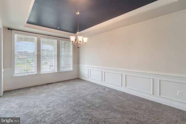 8266 Saint Francis Dr, Severn, MD 21144 - empty room with a raised ceiling, a chandelier, carpet flooring, wainscoting, and ornamental molding
