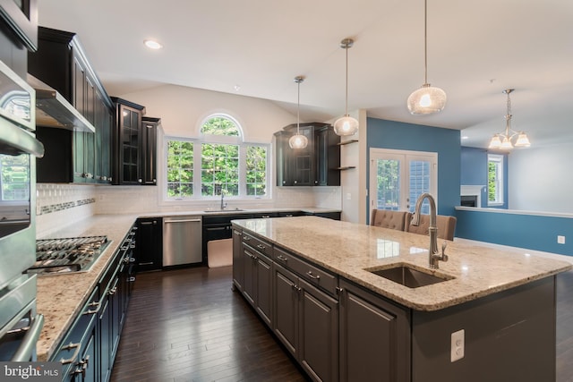 8266 Saint Francis Dr, Severn, MD 21144 - kitchen with appliances with stainless steel finishes, a center island with sink, tasteful backsplash, dark wood-type flooring, and healthy amount of natural light