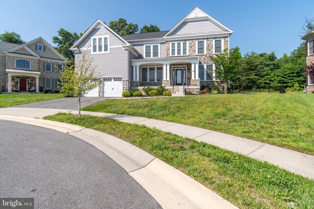 8266 Saint Francis Dr, Severn, MD 21144 - view of front of home with stone siding, a garage, asphalt driveway, and a front lawn