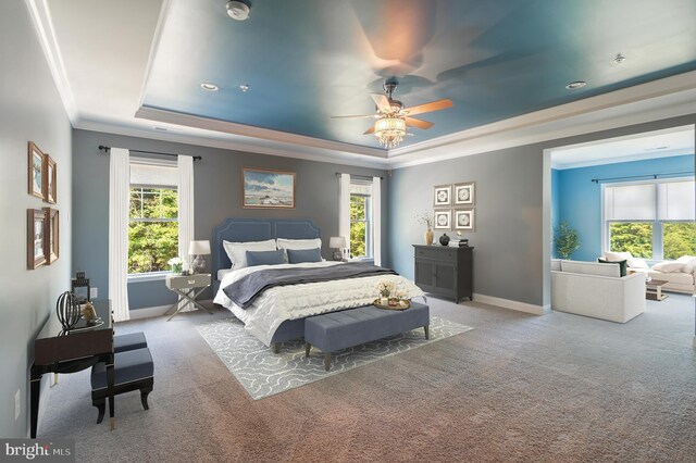8266 Saint Francis Dr, Severn, MD 21144 - carpeted bedroom featuring a raised ceiling, crown molding, multiple windows, and a ceiling fan