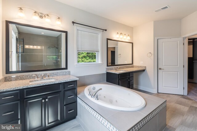 8266 Saint Francis Dr, Severn, MD 21144 - full bathroom featuring a whirlpool tub, two vanities, and tiled shower