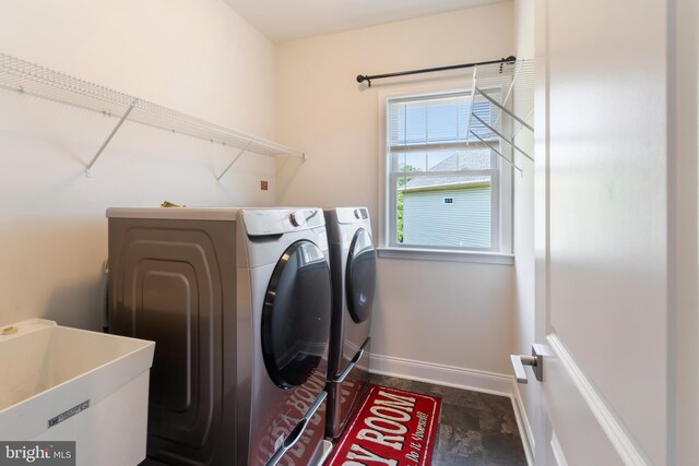 8266 Saint Francis Dr, Severn, MD 21144 - washroom featuring separate washer and dryer and dark stone finish flooring