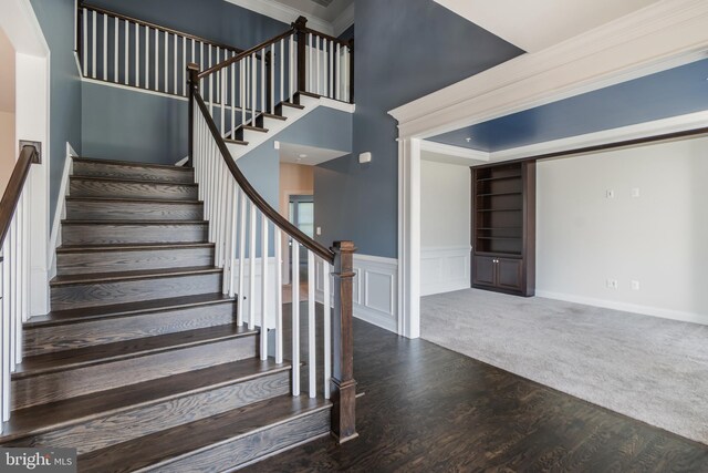 8266 Saint Francis Dr, Severn, MD 21144 - staircase with wood finished floors, a wainscoted wall, and a decorative wall
