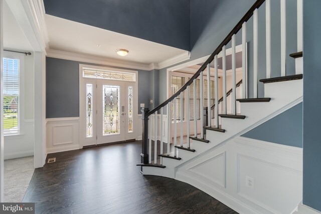 8266 Saint Francis Dr, Severn, MD 21144 - foyer featuring healthy amount of natural light, a decorative wall, stairway, wainscoting, and crown molding