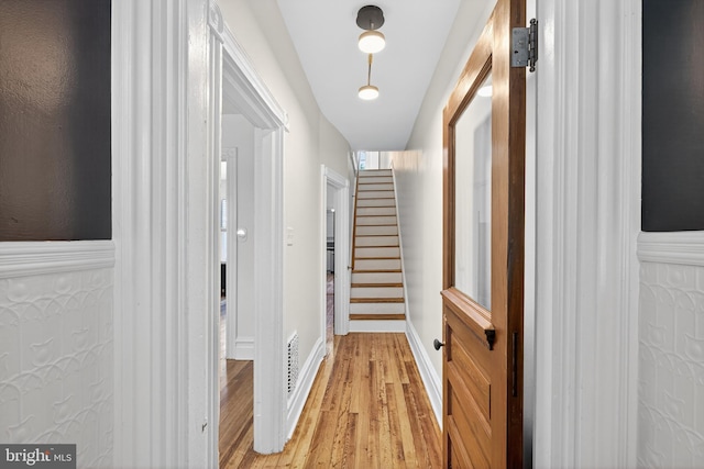 117 Pearl St, Lancaster, PA 17603 - corridor with light wood-style flooring, wainscoting, and stairway