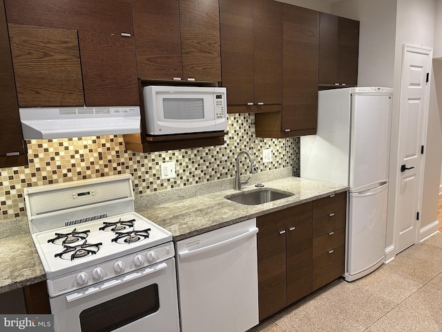 1423 T St NW, Washington, DC 20009 - kitchen with white appliances, under cabinet range hood, backsplash, and dark brown cabinetry