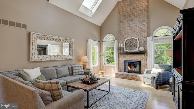 24 Montfort Dr, Belle Mead, NJ 08502 - living room with high vaulted ceiling, a fireplace, wood finished floors, and a skylight