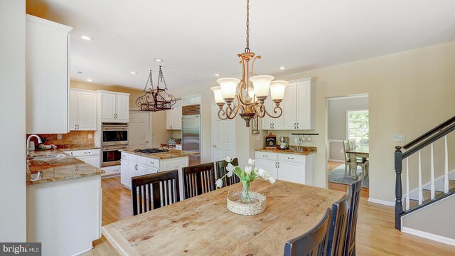 24 Montfort Dr, Belle Mead, NJ 08502 - dining area featuring a chandelier, light wood-style flooring, recessed lighting, and stairs