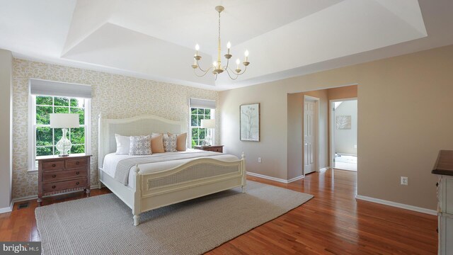 24 Montfort Dr, Belle Mead, NJ 08502 - bedroom with wallpapered walls, multiple windows, wood finished floors, a chandelier, and a tray ceiling