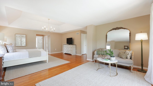 24 Montfort Dr, Belle Mead, NJ 08502 - bedroom featuring wood finished floors, a raised ceiling, and a chandelier