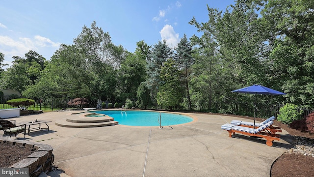 24 Montfort Dr, Belle Mead, NJ 08502 - view of pool with a patio area, view of wooded area, and a pool with connected hot tub