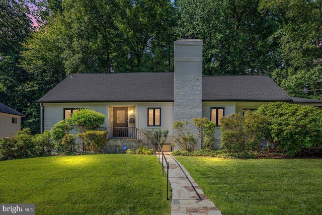 5124 37th St N, Arlington, VA 22207 - view of front of house with brick siding, a front yard, and a chimney