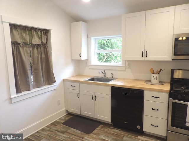 161 Main St, Southampton, NJ 08088 - kitchen featuring appliances with stainless steel finishes, dark wood-type flooring, wooden counters, white cabinetry, and vaulted ceiling
