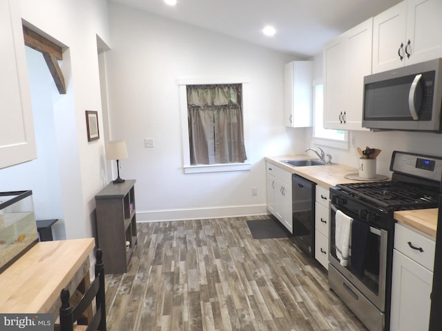 161 Main St, Southampton, NJ 08088 - kitchen featuring appliances with stainless steel finishes, wood counters, wood finished floors, white cabinets, and vaulted ceiling