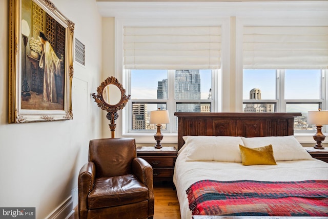 1425 Locust St Unit 33A, Philadelphia, PA 19102 - bedroom featuring wood finished floors, multiple windows, and a city view