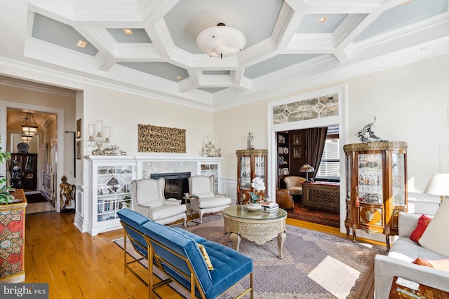 1425 Locust St Unit 33A, Philadelphia, PA 19102 - living area featuring coffered ceiling, crown molding, a fireplace, wood finished floors, and beam ceiling