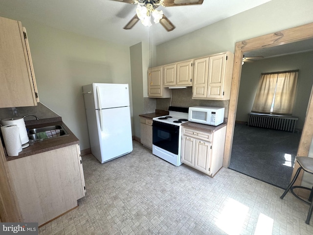 505 W 5th St, Lewistown, PA 17044 - kitchen featuring white appliances, ceiling fan, radiator heating unit, and dark countertops