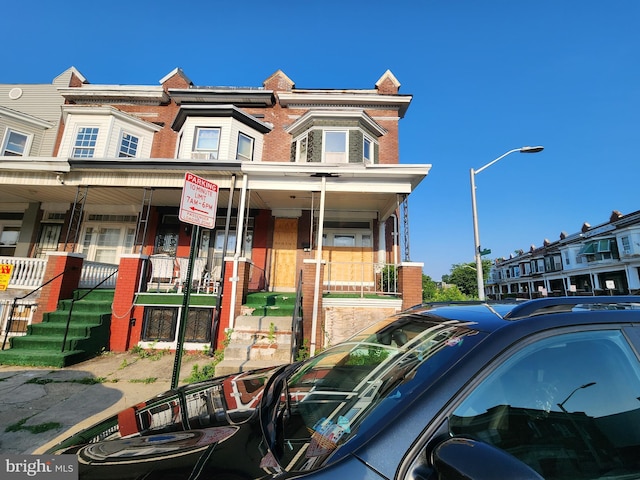 1226 Bloomingdale Rd, Baltimore, MD 21216 - view of property featuring covered porch and brick siding