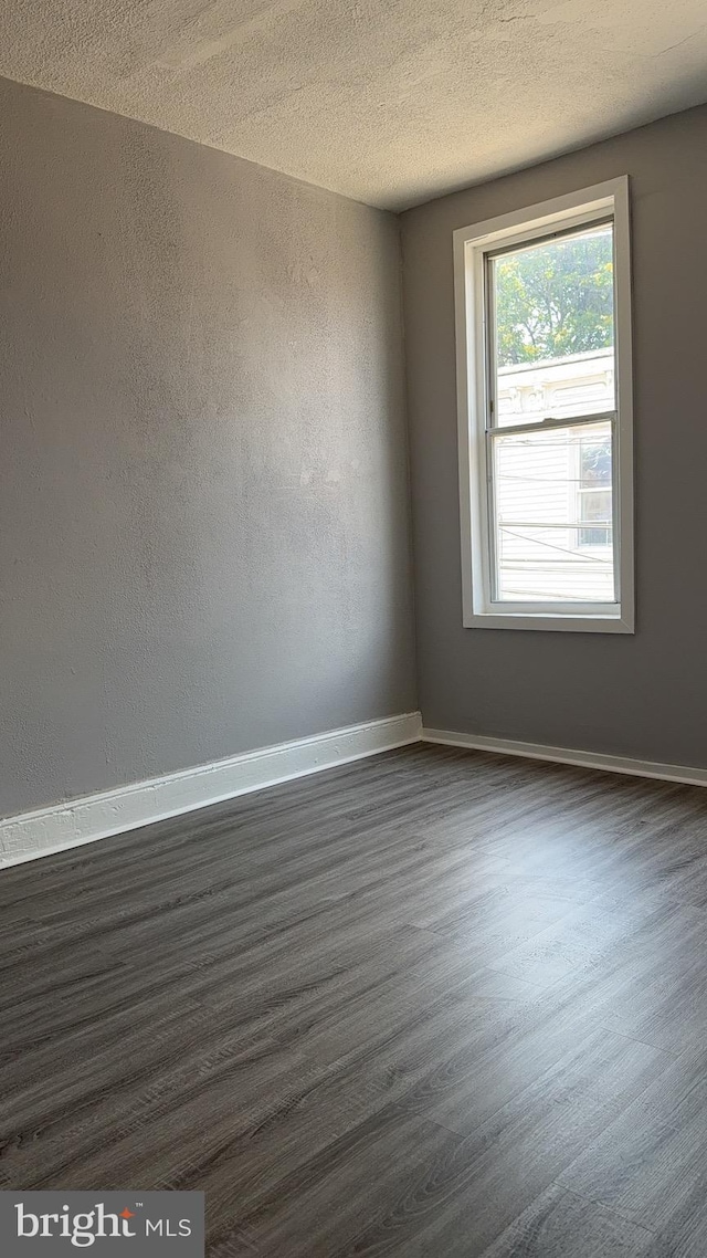 2863 N Leithgow St, Philadelphia, PA 19133 - empty room with dark wood finished floors and a textured ceiling