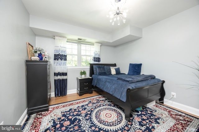 7093 Spring Garden Dr Unit 202, Springfield, VA 22150 - bedroom featuring wood finished floors and a chandelier