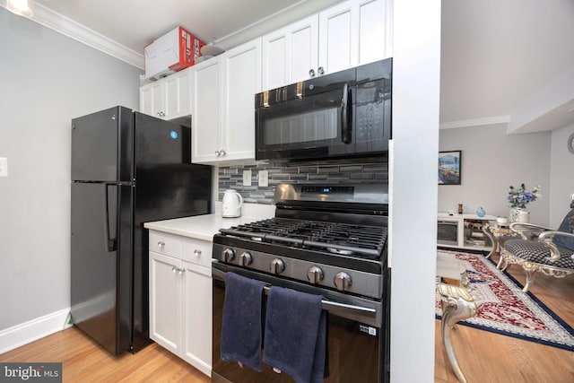 7093 Spring Garden Dr Unit 202, Springfield, VA 22150 - kitchen with black appliances, ornamental molding, light wood-style flooring, white cabinets, and tasteful backsplash