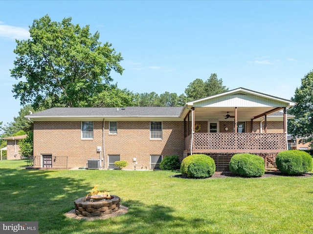 117 Amherst Ct, Stephens City, VA 22655 - rear view of house with ceiling fan, a yard, a fire pit, and brick siding