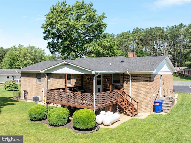 117 Amherst Ct, Stephens City, VA 22655 - back of property featuring brick siding, a lawn, a chimney, a shingled roof, and a wooden deck