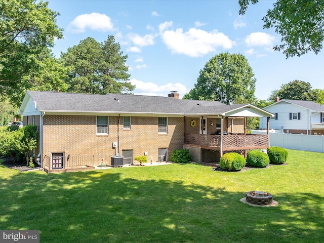 117 Amherst Ct, Stephens City, VA 22655 - rear view of property featuring an outdoor fire pit, brick siding, a wooden deck, and a chimney