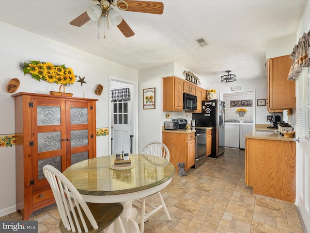 117 Amherst Ct, Stephens City, VA 22655 - dining room with washing machine and clothes dryer, stone tile floors, and a ceiling fan