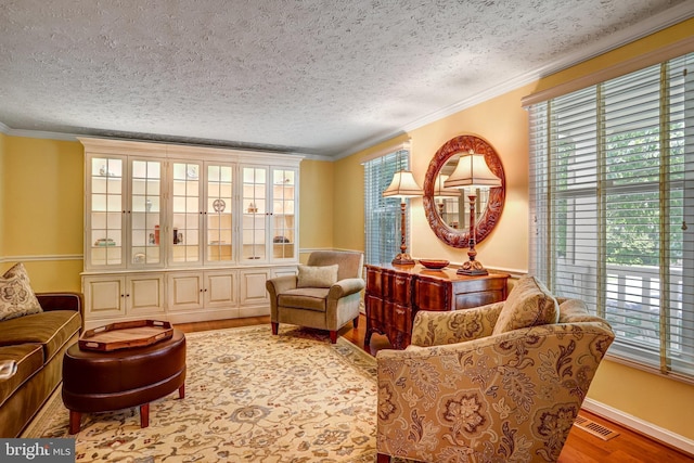 20304 Watkins Meadow Dr, Germantown, MD 20876 - living area with plenty of natural light, wood finished floors, a textured ceiling, and ornamental molding